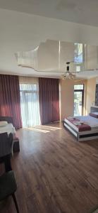 a large room with two beds and a ceiling at MAHALI HOTEL in Batumi