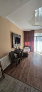 a room with a bed and a table and chairs at MAHALI HOTEL in Batumi
