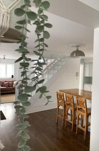 a living room with a table and a plant at La Villa Rustique-2 in Notre-Dame-du-Lac +17 photos