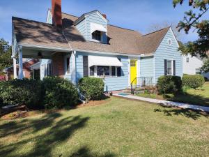 a house with a yellow door and a yard at A Salter's Path in Beaufort