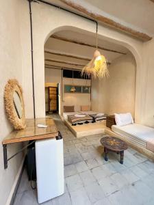 a living room with a couch and a table at Riad Atlas Surf in Tamraght Ouzdar