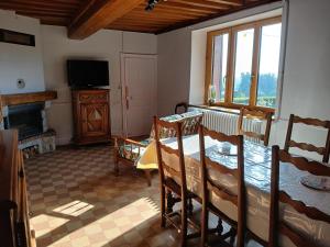 a living room with a table and a television at GITE Les Tulipes in Liernais