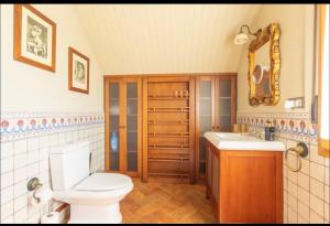 a bathroom with a toilet and a sink and a mirror at Casa Santiago in Argoños +36 photos