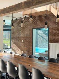 a conference room with a long wooden table and chairs at Moulin de Baillonville in Baillonville +81 photos