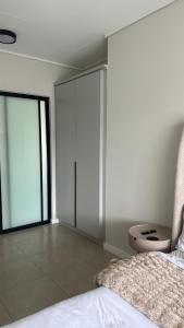a bedroom with sliding glass doors and a bed at Elara in Sandton