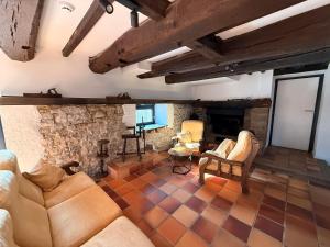 a living room with a couch and a fireplace at Moulin de Baillonville in Baillonville