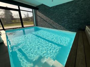 a large swimming pool in a house at Moulin de Baillonville in Baillonville