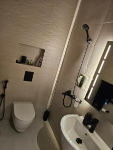 a white bathroom with a toilet and a sink at دار طيبة in Medina +8 photos