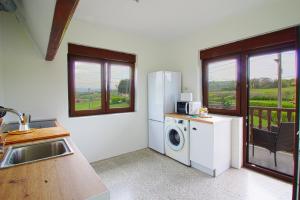 a kitchen with a refrigerator and a washing machine at La balcon de Sanfer in Santillana del Mar +7 photos