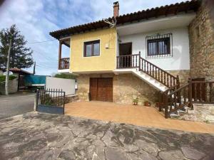 a house with a staircase in front of it at La balcon de Sanfer in Santillana del Mar