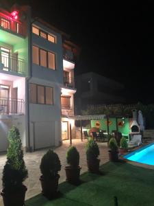 a building with a swimming pool at night at Villa Rocky in Sozopol