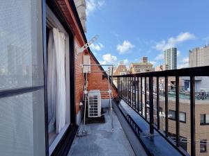 a balcony with a heater on the side of a building at Mori house ookubobiru in Tokyo