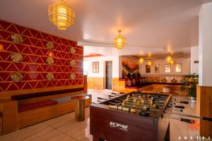 a living room with a pool table and a couch at Zostel Dharamkot, Bhagsu in McLeod Ganj