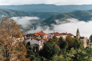 a town on a hill with fog in the valley at The View in Motovun