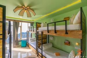 a room with four bunk beds in a room at Zostel Dharamkot, Bhagsu in McLeod Ganj