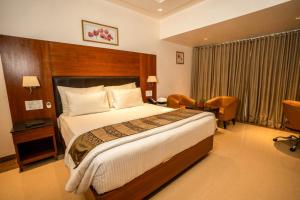 a bedroom with a large bed in a hotel room at Southern Star,Davangere in Dāvangere +29 photos