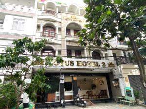 a building with a us hotel sign in front of it at LotusHotel 2 in Ho Chi Minh City