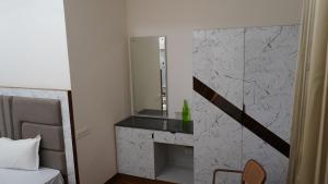 a bathroom with a fireplace with a mirror on the wall at PD Residency in Duttnager +21 photos