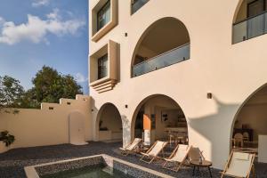 a house with a swimming pool and chairs at Mountain Resort Hotel in Dali