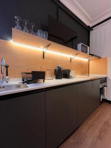 a kitchen with a counter with a sink and a counter top at Terrazas de la Catedral II in Castellón de la Plana +20 photos