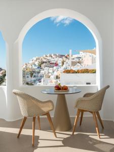 a dining room with a table and chairs and a window at Aspaki by Art Maisons in Oia