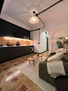 a living room with a couch and a table at Terrazas de la Catedral II in Castellón de la Plana