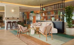 a living room with a couch and chairs at DoubleTree by Hilton Rotterdam Centre in Rotterdam