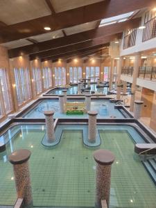 a large indoor swimming pool in a building at Beach 101 Villa in Siófok