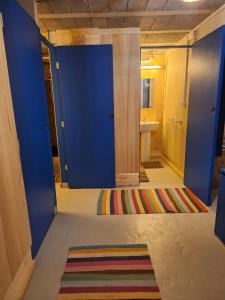 a room with blue walls and a rug on the floor at Les Renaudières Chalais in Chalais