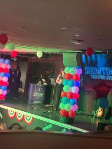 a band playing on a stage with balloons at Sandylands caravan park in Stevenston