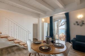 a dining room with a table and chairs and a staircase at Tenuta La Chiusa in Portoferraio