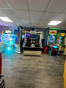 a room with two arcade games and a video game at Sandylands caravan park in Stevenston