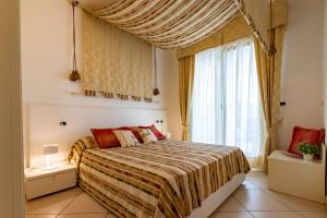 a bedroom with a bed and a large window at Ashanti Aparthotel Wellness&Spa in Bibione +163 photos