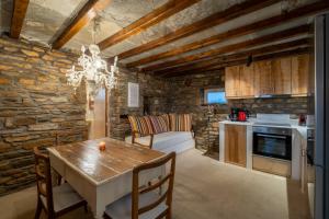 a kitchen and dining room with a table and chairs at Akrotiraki Villas in Tinos