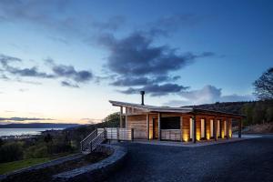 a wooden cabin with a view of the water at Kelburn Yurts - Bourtrees in Fairlie
