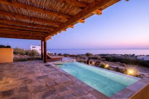 a swimming pool in a villa with a view at Akrotiraki Villas in Tinos