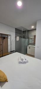 a room with a bed with two towels on it at Cais 75 Studios & Suites in Aveiro +287 photos