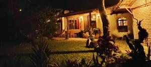 a house at night with the lights on at Hospedaria Quintal dos Sonhos in Vale do Capao +8 photos