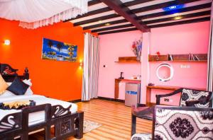 a bedroom with orange and pink walls and a bed at Kijiji Beach Resort in Dar es Salaam