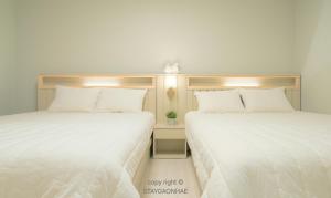 two beds sitting next to each other in a room at Stay Gaonhae in Gyeongju