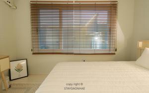 a bedroom with a bed with a large window at Stay Gaonhae in Gyeongju +17 photos