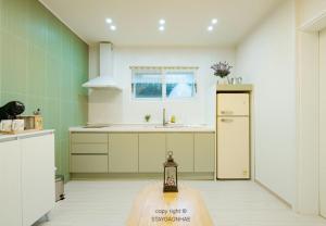 a kitchen with a table in the middle of it at Stay Gaonhae in Gyeongju
