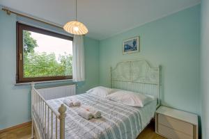 a bedroom with a bed with two stuffed animals on it at Apartma pri Cesarjevih in Sežana