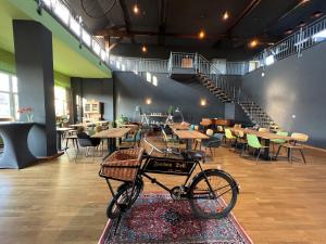 a bike parked in a room with tables and chairs at Gästehaus & Café Leeze in Bad Dürkheim