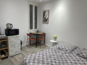 a bedroom with a bed and a table and chairs at Studio proche vieux port in Marseille
