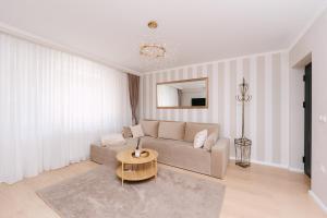 a living room with a couch and a table at Sovata Apartment in Sovata