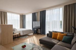 a living room with a couch and a bedroom at Vila Eva in Golem