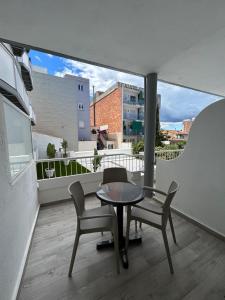a balcony with a table and chairs and a view at Hotel Apartamentos Solimar in Calafell