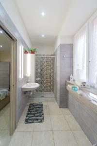 a bathroom with a sink and a shower at Guest House Margherita in Caserta +47 photos