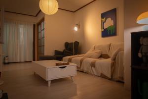 a living room with a bed and a coffee table at 퍼즈스테이 Pause Stay in Chuncheon